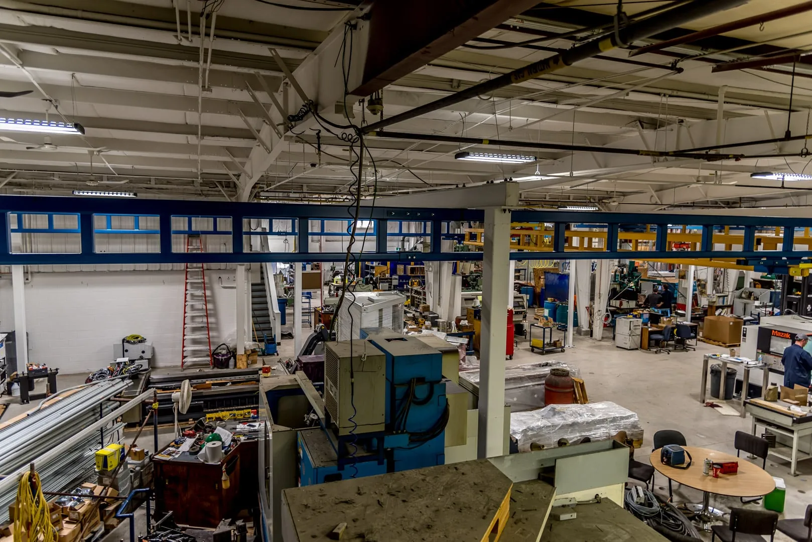 Manufacturing plant floor with new overhead lighting and machinery