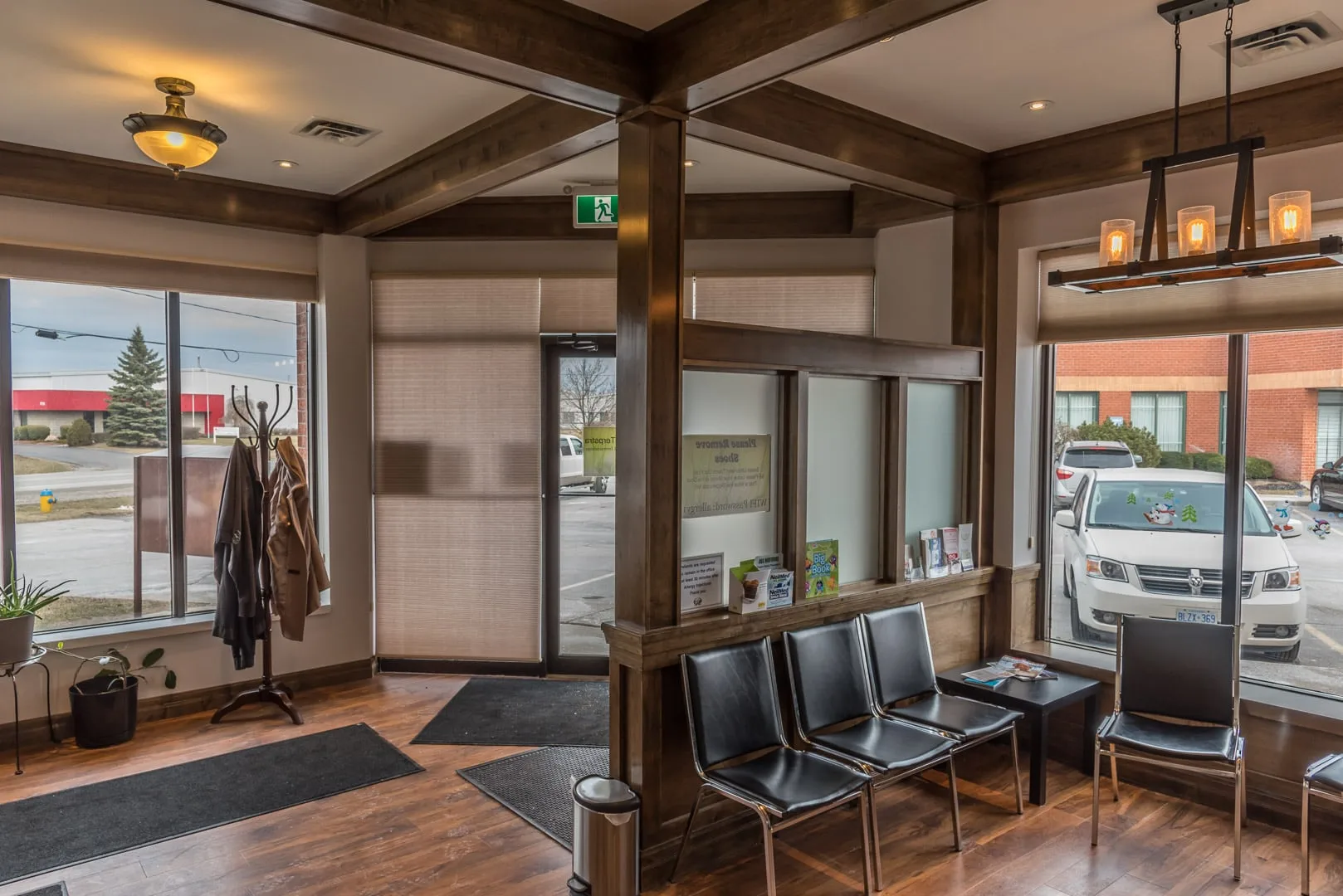 Renovated office reception with wood trim and pendant lighting